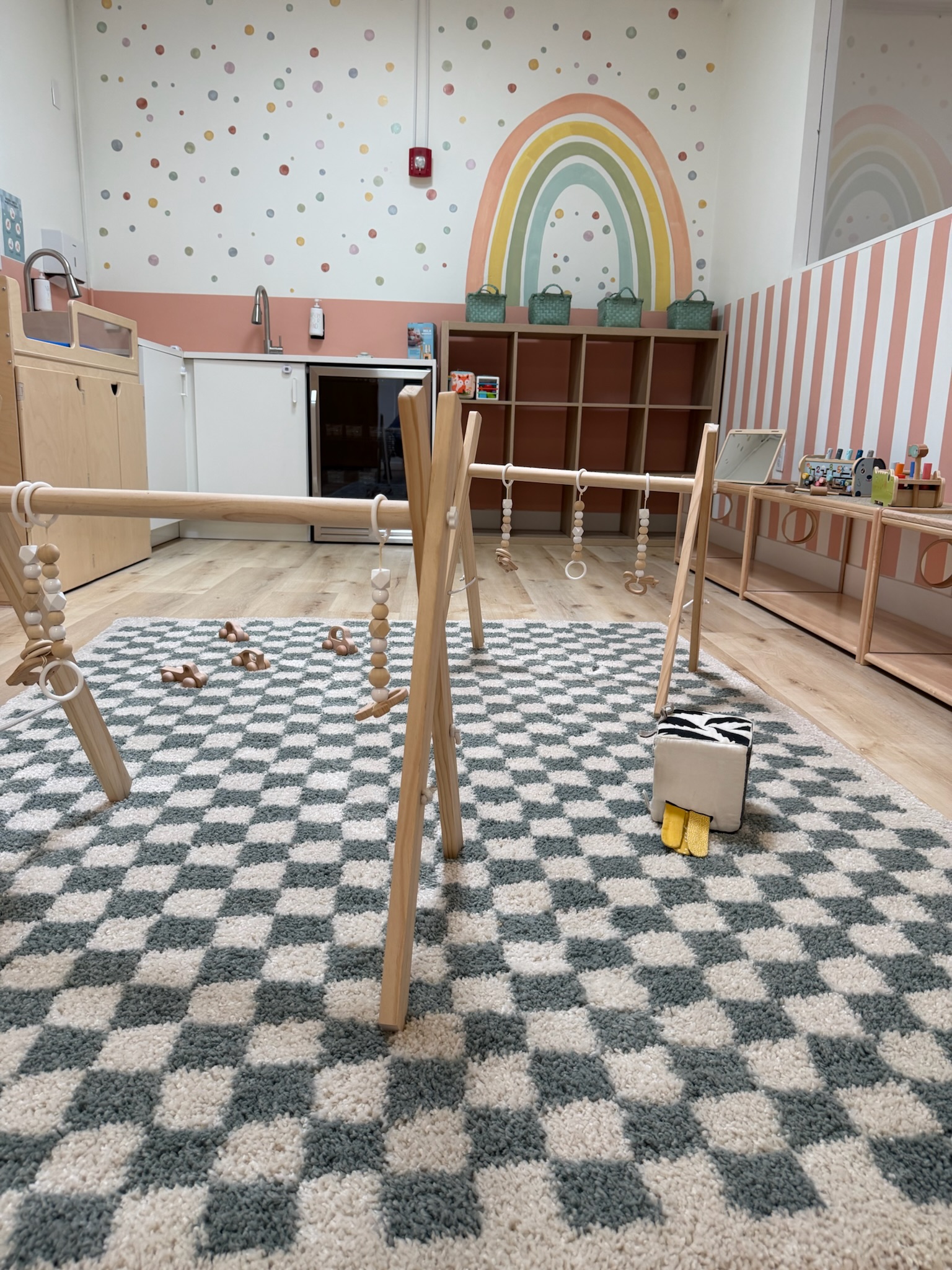 Happy Nook infant play area with wooden play gym and rainbow wall